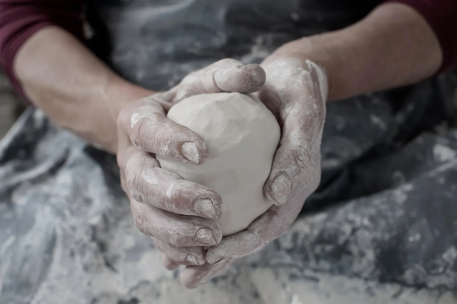 Clay workshop session during a Casa Alma retreat, hands shaping pottery in a serene setting