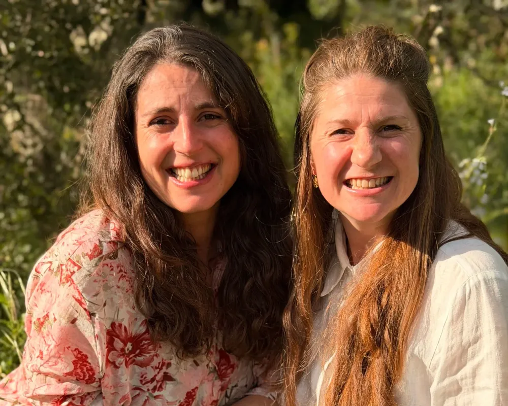 Ana and Myrna, founders of Casa Alma, smiling together in the Alentejo countryside
